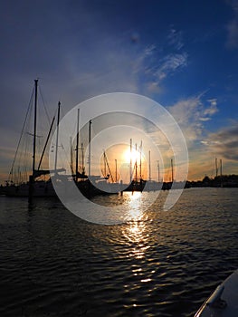 Harbor sunset view blue sky boats and flat water