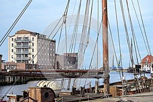 Harbor of Wismar on the Baltic Sea with a historical sailing ship in the foreground, tourist magnet in the old hanseatic town,