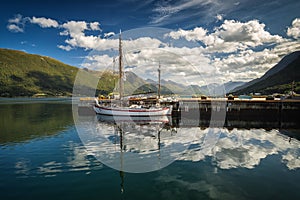 Harbour in Andalsnes, norwegian summer, beautiful reflections of sky and boat