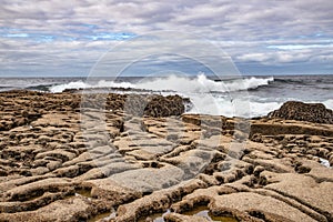 Harbour beach with waves and rocks