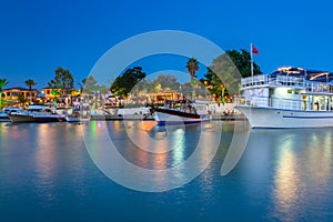 The harbour with boats in Side at night, Turkey photo