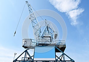 Harbour crane on which an empty advertising poster is attached for self-labelling