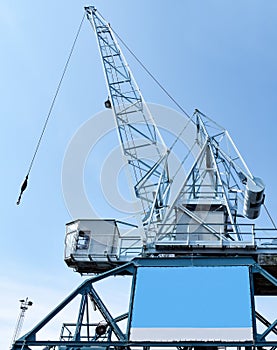 Harbour crane on which an empty advertising poster is attached for self-labelling