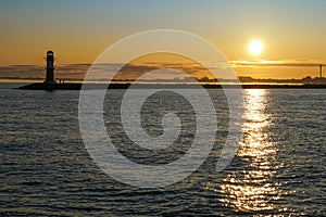 The harbour entrance in WarnemÃ¼nde and the Baltic sea during sunrise