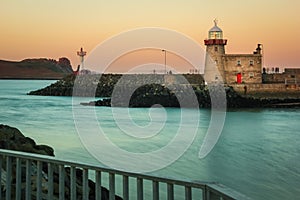 Harbour lighthouse at sunset. Howth. Dublin. Ireland photo