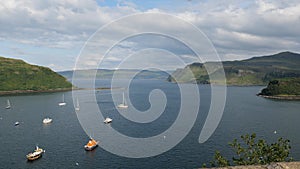 Harbour in Portree, Isle of Skye, Scotland at early sunset with a lot of ships