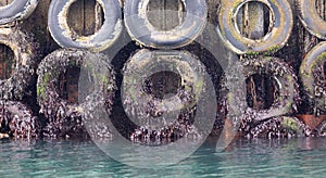 Harbour wall with old tyres for protection