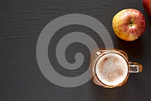 Hard Apple Cider Ale in a Glass Jar Mug on a black background, top view. Flat lay, overhead, from above. Copy space