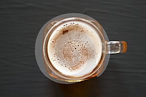 Hard Apple Cider Ale in a Glass Jar Mug on a black surface, top view. Flat lay, overhead, from above