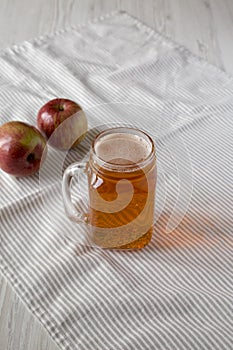 Hard Apple Cider Ale in a Glass Jar Mug on cloth, low angle view