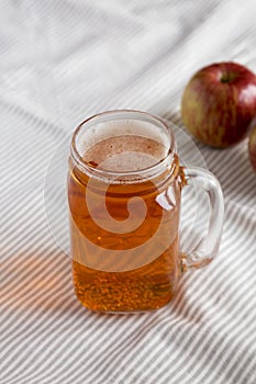 Hard Apple Cider Ale in a Glass Jar Mug on cloth, low angle view