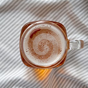 Hard Apple Cider Ale in a Glass Jar Mug on cloth, top view. Flat lay, overhead, from above. Close-up