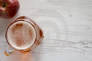 Hard Apple Cider Ale in a Glass Jar Mug on cloth, top view. Flat lay, overhead, from above. Space for text