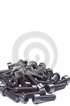 Hard black inbus screws isolated above white background with copy space