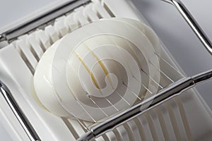 Hard boiled egg in an egg slicer