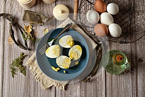 hard boiled eggs on blue plate with ingredients around