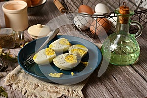 hard boiled eggs on blue plate with ingredients around