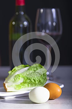 Hard boiled eggs with fresh lettuce and wine