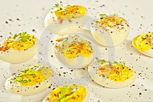 Hard boiled eggs, sliced in halves are isolated on white background