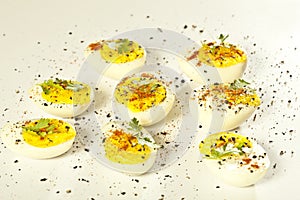 Hard boiled eggs, sliced in halves are isolated on white background