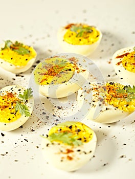 Hard boiled eggs, sliced in halves are isolated on white background
