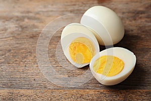 Hard boiled eggs on wooden table.