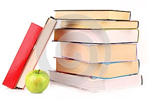 Hard cover books and green apple