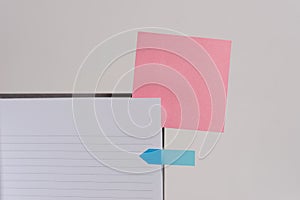 Upper view striped lined hard cover note book blank color sticky note arrow banner inserted clear background. Reminder