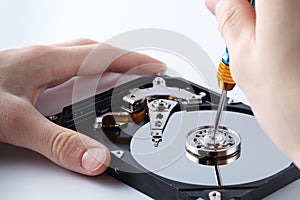 Hard disc drive disassembling close up. Repairman opening hdd for recovery information, service center and electronics repair con