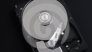 Hard disk drive inside with rotating platter and arm