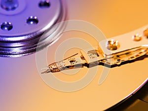 Hard disk drive inside, toned, closeup magnetic head and disk surface