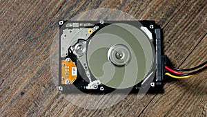 A Hard Disk Drive is open, broken and spin out
