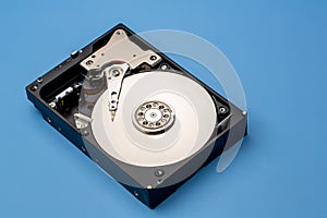 Hard disk drive and open cover. Computer hardware, hard disk, storage device. Detail of the inside of a hard disk drive. Hard disk
