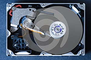 Hard disk drive with removed cover, hdd inside flat view, spindle, actuator arm, read write head, platter, ribbon cable