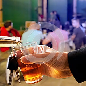 Hard drinker with liqueur glass and car key