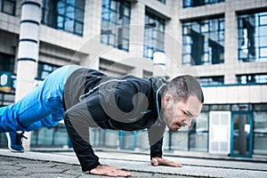 Hard exercise for body. Sporty man.