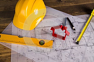 Hard hat with blueprints and rulers