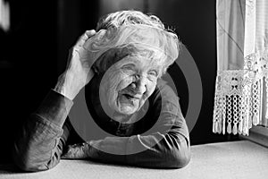 Hard-of-hearing old woman put her hand to her ear. Black and white photo.