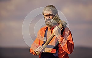 Hard labour. Brutal bearded man axe in hands. Brutal and bearded. Builder with axe. Use axe construction. Renovation