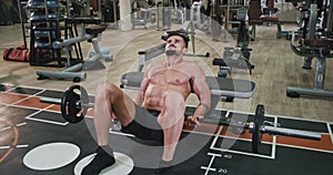 Hard muscle body athletic man exercises to get more muscle in a modern gym class he are very concentrated doing his