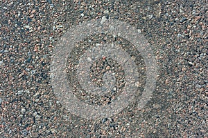 Hard road surface consisting of many stones mixed with asphalt