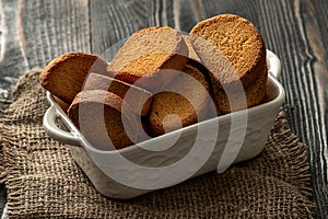 Hard rusk chuck crackers on wooden table. Hard dry bisquits photo