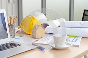 Hard safety helmet hat, construction equipment, blueprint on table in office worker conference site, architect working desk.