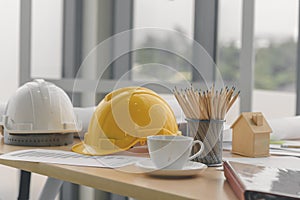 Hard safety helmet hat, construction equipment, blueprint on table in office worker conference site, architect working desk.