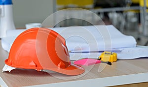 Hard safety helmet hats, construction equipment, blueprint on the table in conference office worker, architect working desk.