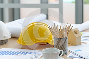 Hard safety helmet hats, construction equipment, blueprint on the table in conference office worker, architect working desk.