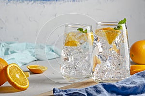 Hard seltzer cocktail with orange, mint and ice