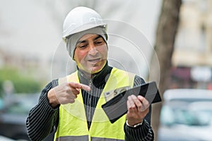 Bad times: poor construction worker and his empty wallet