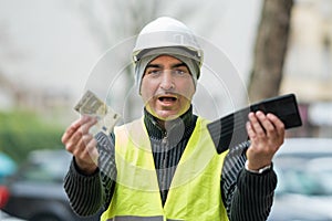 Bad times: poor construction worker and his empty wallet