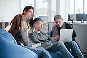 Hard to find information that we need. Group of young people in casual clothes working in the modern office